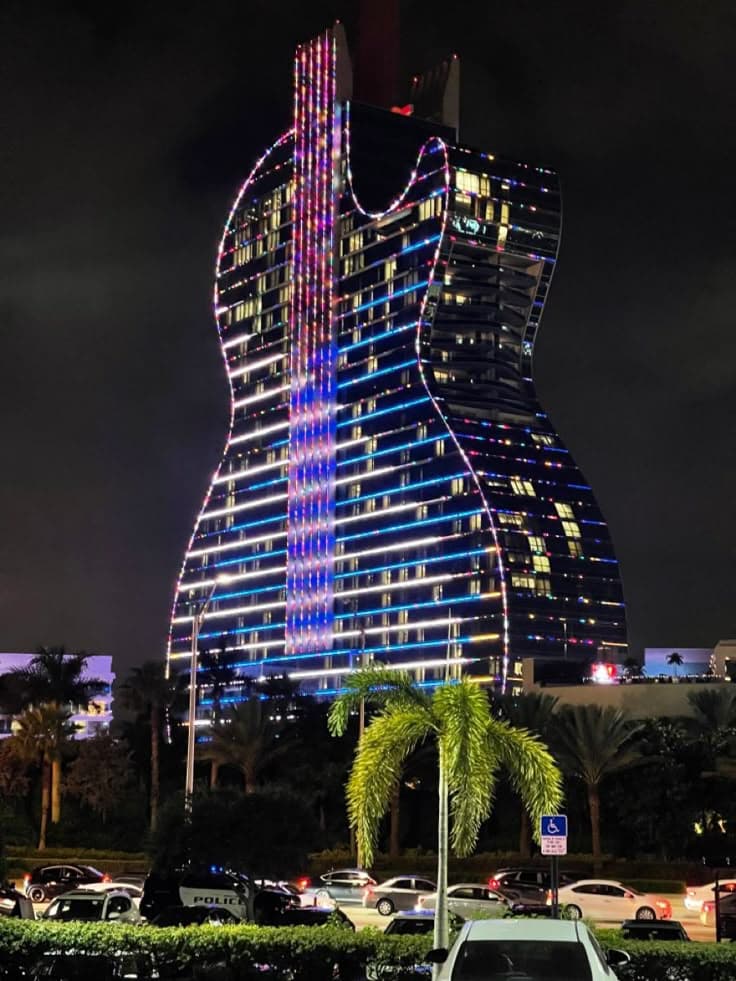 a large guitar shaped building lit up at night