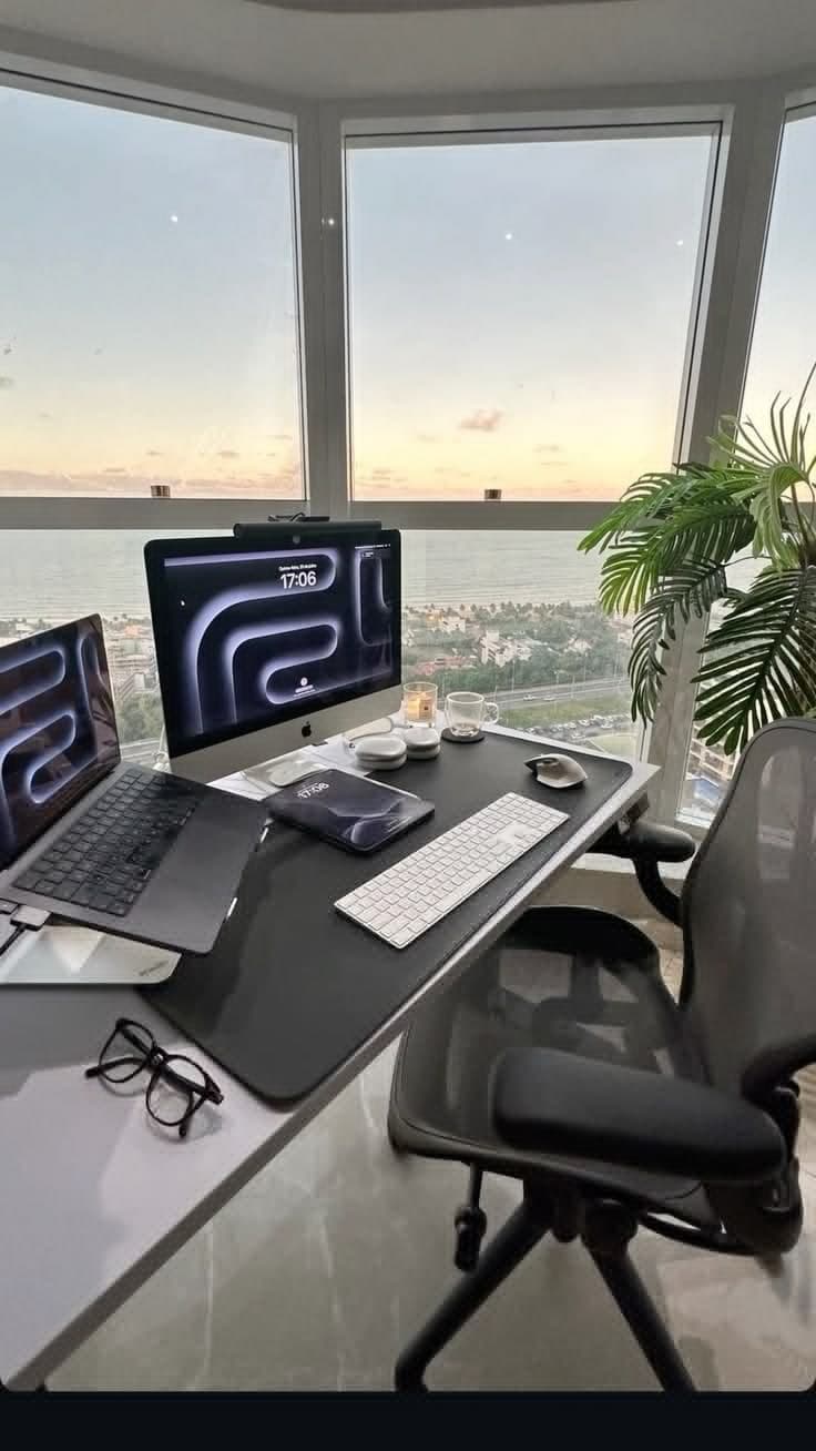home-office desk setup with iMac, MacBook and ocean view