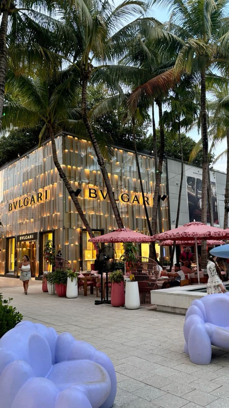 an outdoor cafe with palm trees surrounding it