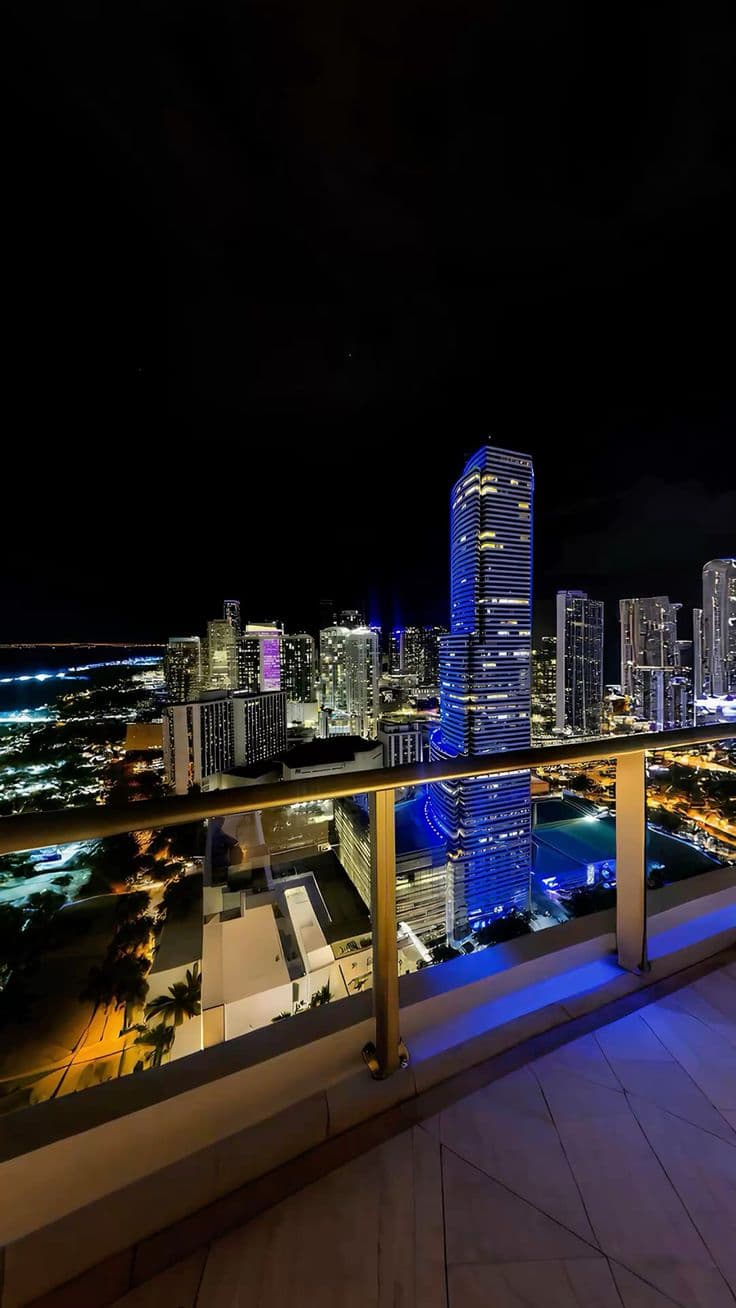 a balcony overlooking the city lights at night