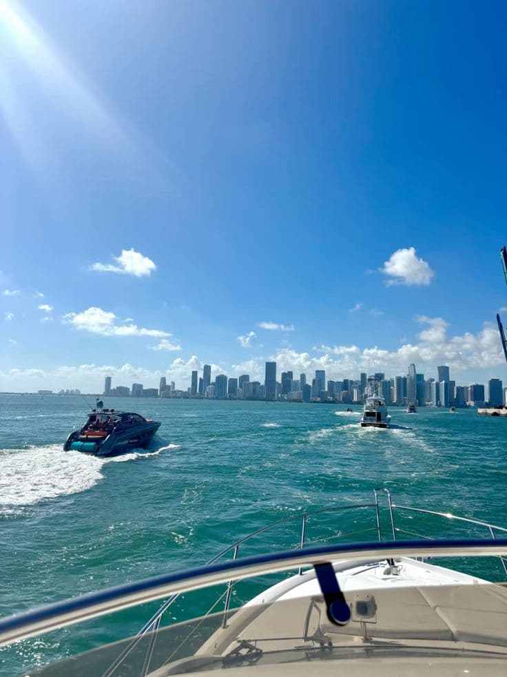 a boat traveling through the ocean with a city in the background