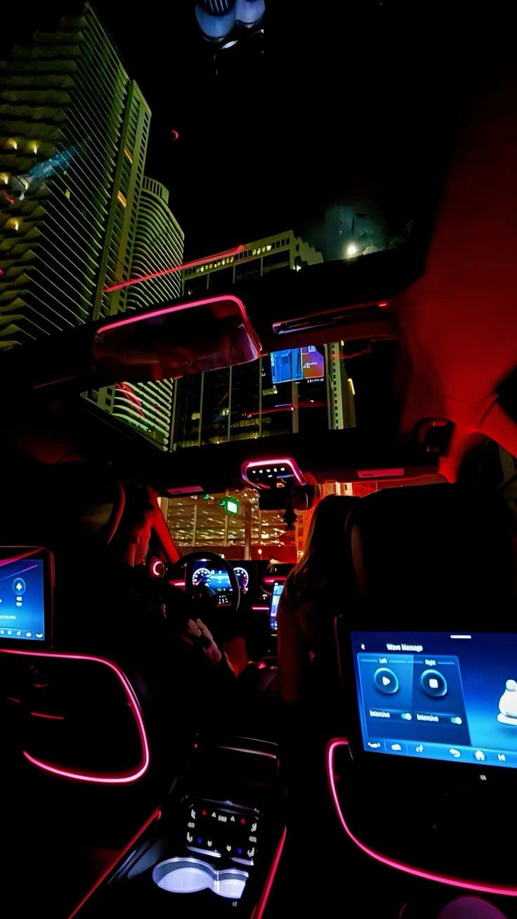 the interior of a car with neon lights
