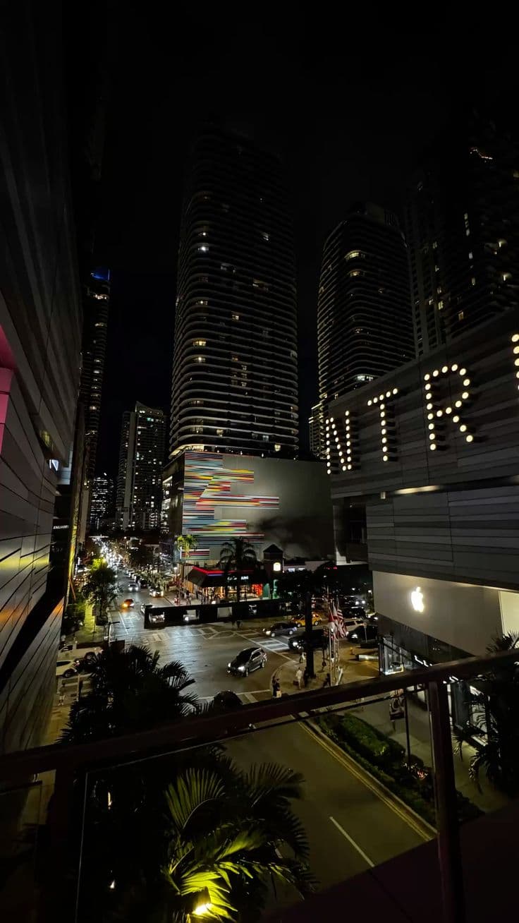 the city skyline is lit up at night