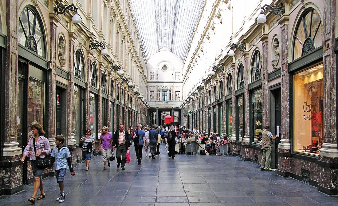 Ornate 19th-century luxury shopping arcade lined with shops, a literal constellation of consumer goods signaling taste and identity