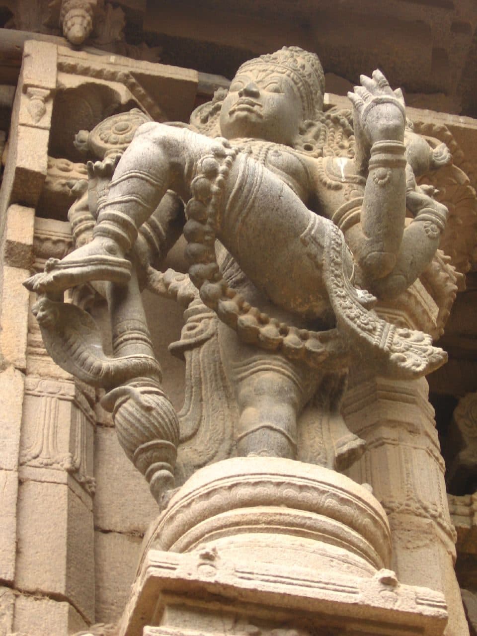 A carved stone gatekeeper (dvarapala) guarding a temple gateway, the literal namesake of gatekeeping