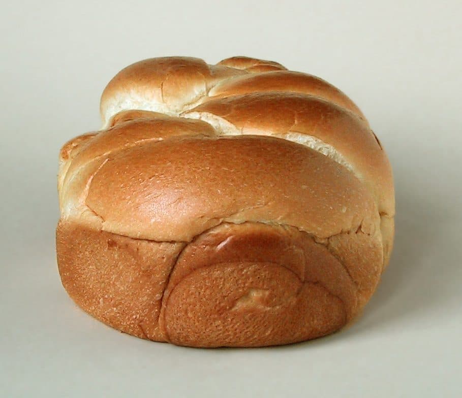 A golden-brown brioche loaf with a deeply browned crust from the Maillard reaction