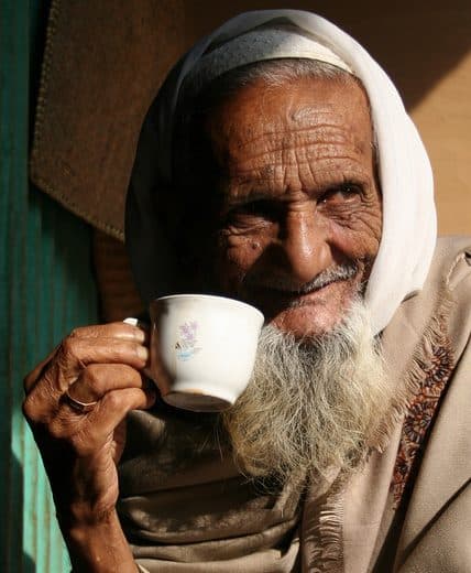 Close-up of an elderly person's deeply wrinkled, sagging facial skin